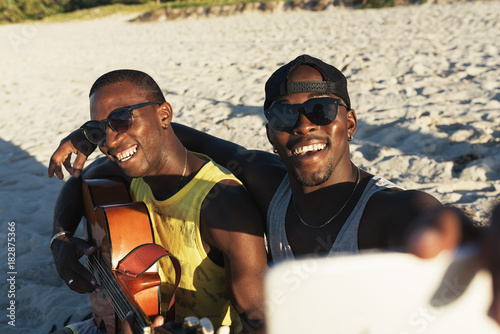 Photography Two cuban friends taking selfie with his mobile.