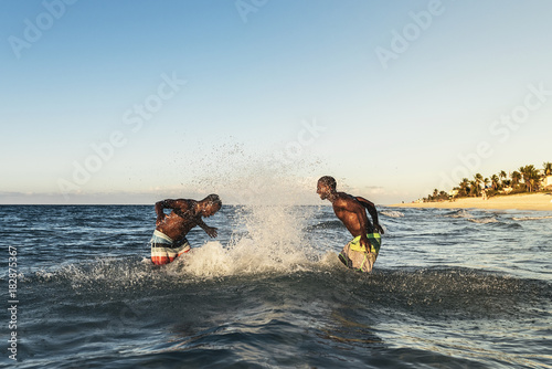 Two cuban friends having fun in the beach. © santypan