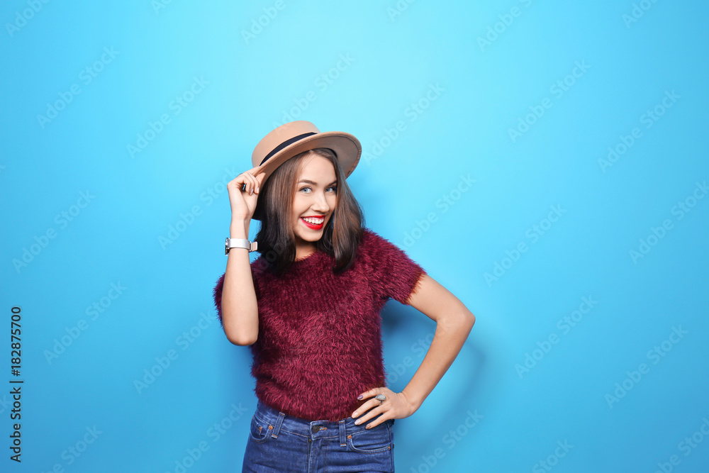 Attractive hipster girl in hat on color background Attractive hipster girl in hat on color background