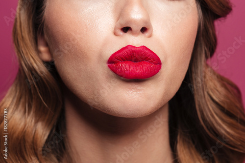 Young lady with red lips making kiss isolated