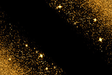 Defocused gold glitter with glowing sparks on black background