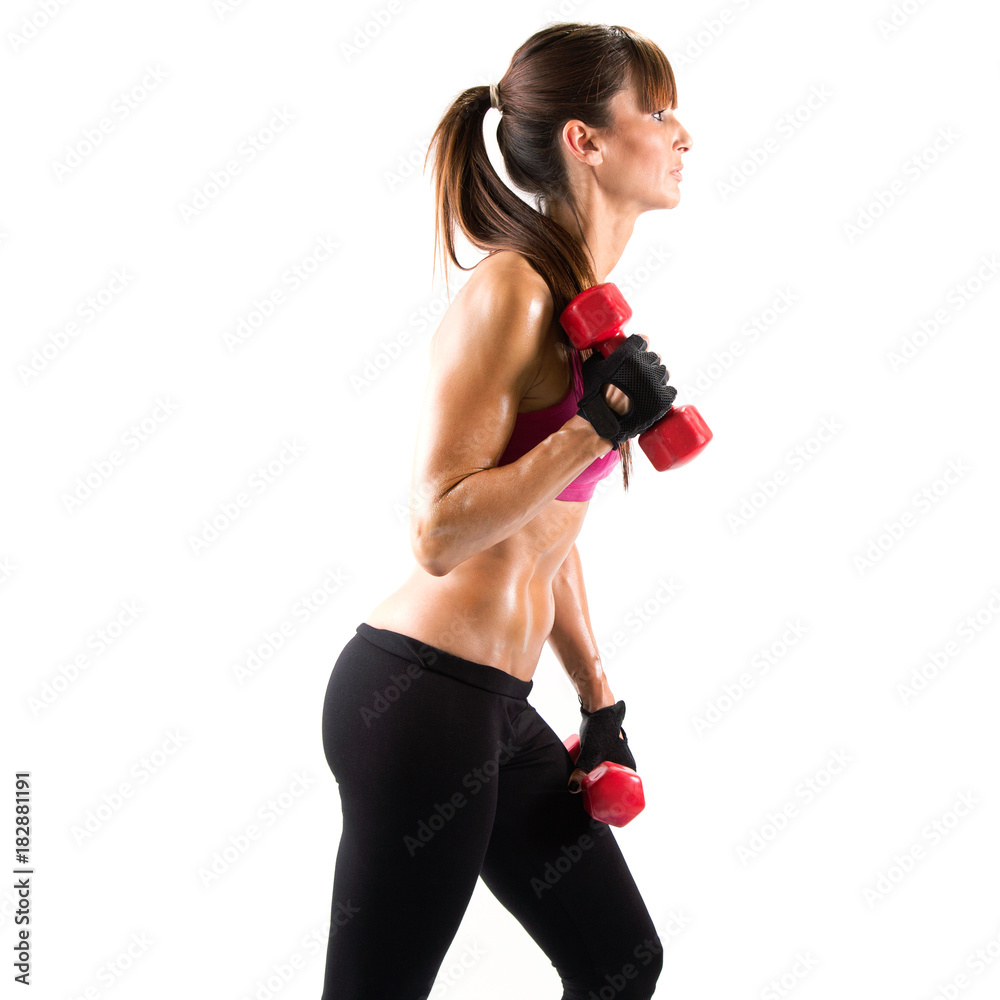 Fit and sporty young woman lifting dumbbells over white background. Fit and sporty young woman lifting dumbbells over white background.