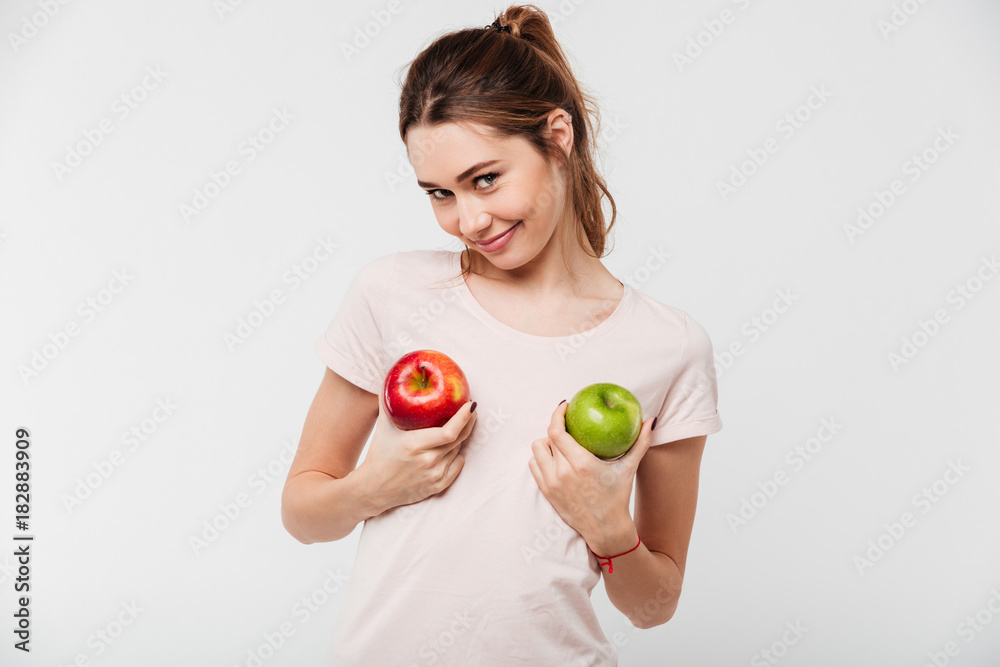 Portrait of a funny happy girl holding apples Portrait of a funny happy girl holding apples