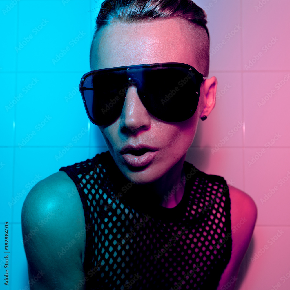 Tomboy Girl with short hair and luxury sunglasses. Fashion Party Style Club  neon light Stock Photo | Adobe Stock