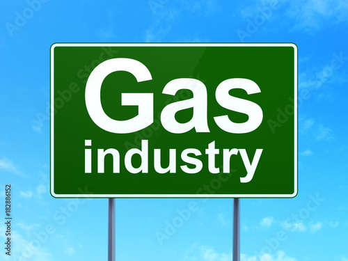 Manufacuring concept: Gas Industry on green road highway sign, clear blue sky background, 3D rendering