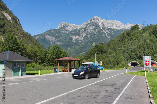 Austrian highway A10 with car park near Hohenwerfen with traffic leaving a tunnel through the mountains