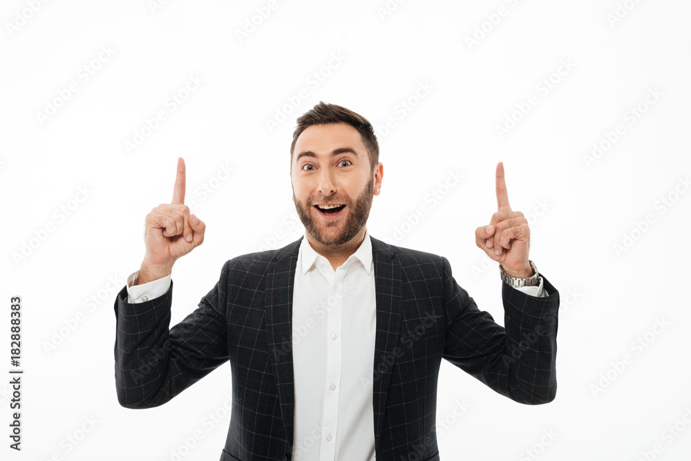 Portrait of a happy cheerful man pointing two fingers up Portrait of a happy cheerful man pointing two fingers up
