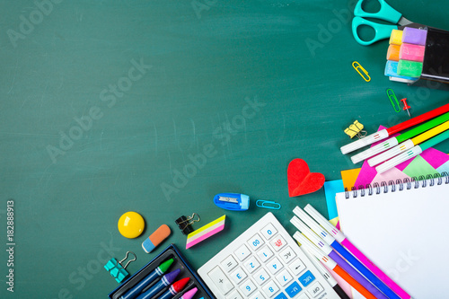 School and office supplies on blackboard