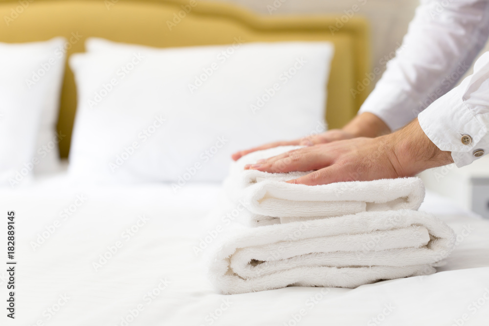 hotel staff setting up pillow on bed hotel staff setting up pillow on bed