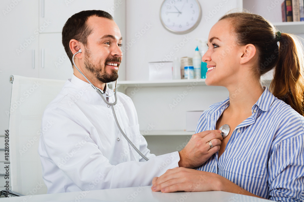 Fototapeta premium Woman having consultation with male doctor in hospital
