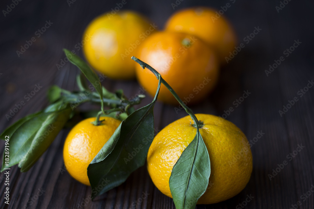 tangerines on a dark wooden table