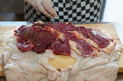 The chef prepares the meat and the skin of sheep's fat to cook roll,salt,spices.Uzbek cuisine.