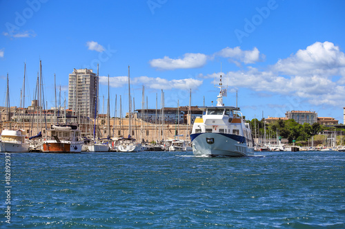 Selective focus on ferry boat at old port in Marseille, France with blue sky 