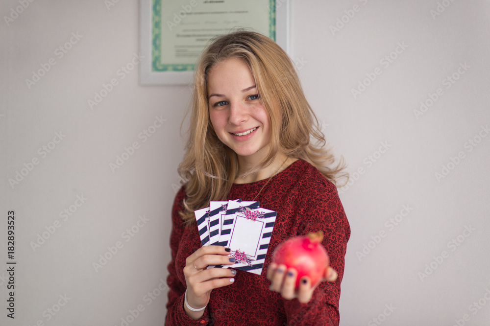 A pretty girl in a sweater holding in his hand the gift tickets 9041. A pretty girl in a sweater holding in his hand the gift tickets 9041.