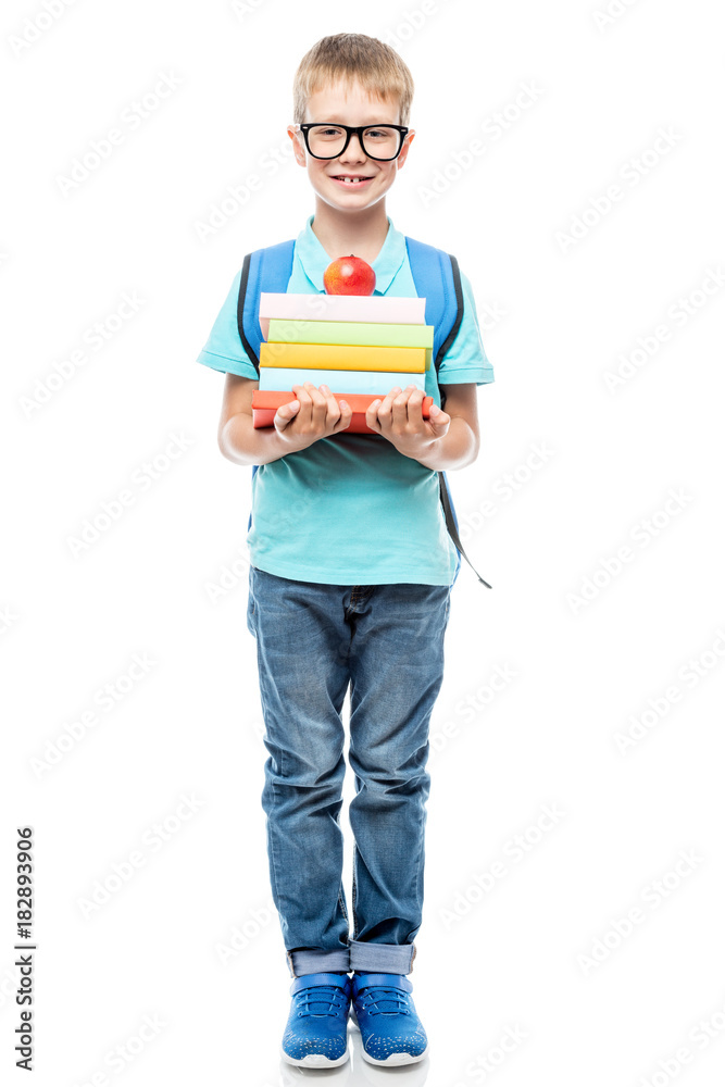 smart schoolchild with glasses with a pile of books and an apple on a white background isolated smart schoolchild with glasses with a pile of books and an apple on a white background isolated