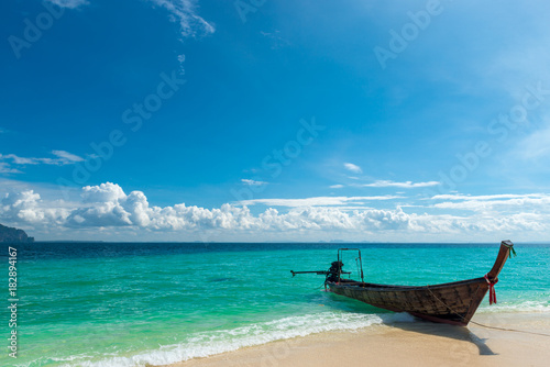 traditional Thai boat long tail near the shore in the turquoise sea, Poda island, Thailand © kosmos111