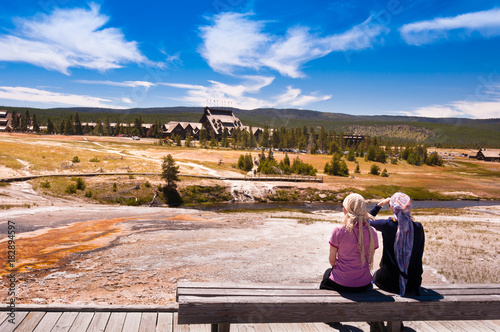 Two women sitting on a bench in the yellowstone national park