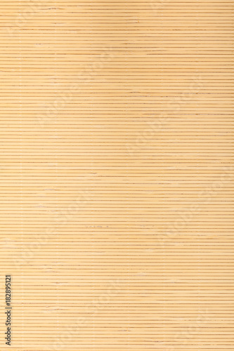 Close up beige brown bamboo mat striped background texture pattern