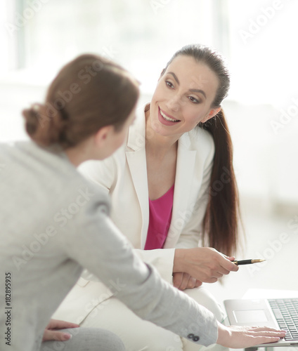 two women designers working on laptop