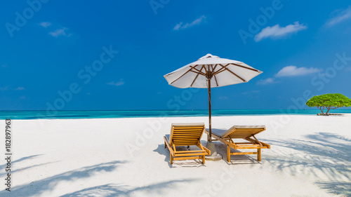 Beautiful beach. Chairs on the sandy beach near the sea. Summer holiday and vacation concept. Inspirational tropical scene. Tranquil scenery  relaxing tropical landscape design