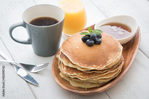 isolated blue berry pancake with  syrup and drink