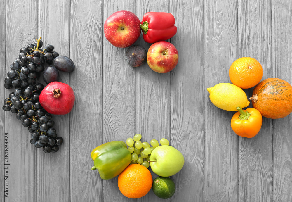 Various fruits and vegetables on wooden background