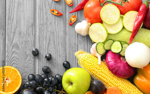 Various fruits and vegetables on wooden background