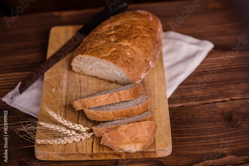 crusty fresh bread on a wood background
