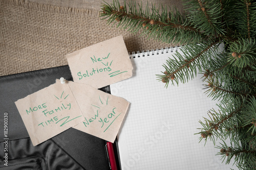 notes reminders and goals, a business notebook, on the next new year background with Christmas fir branches