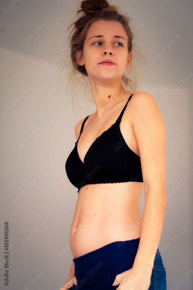 Fototapeta premium proud young pregnant woman wearing a bra