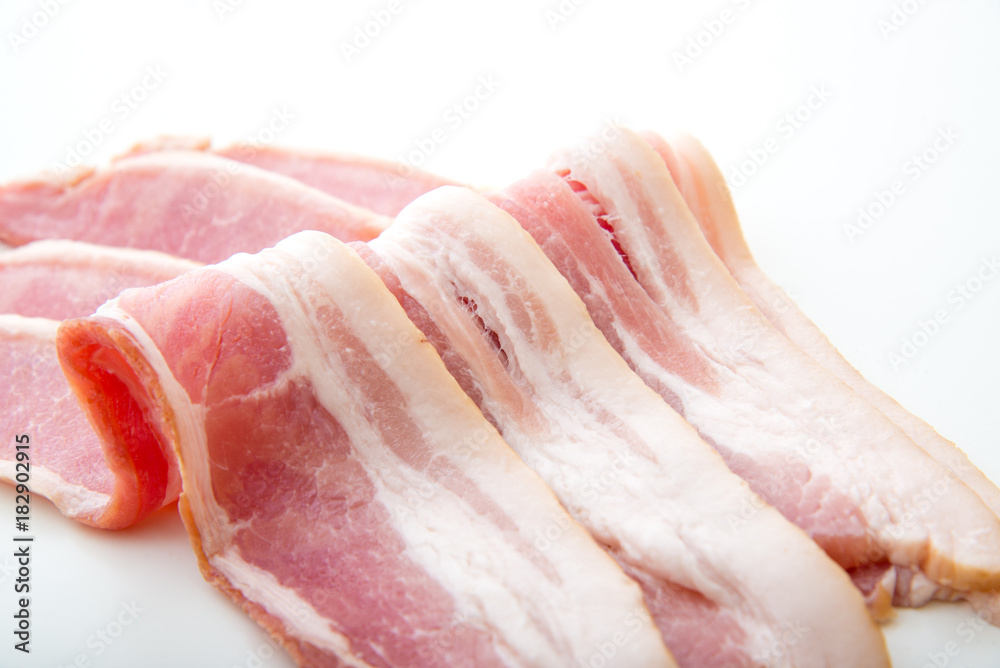 isolated raw bacon on white background