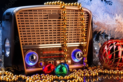 radio receiver in retro style with christmas decorations on black background