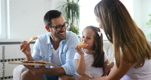 Happy family sharing pizza together at home