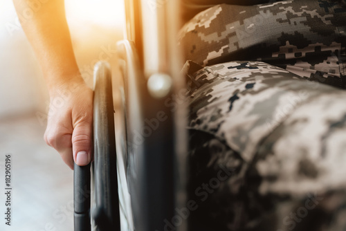 Woman veteran in wheelchair returned from army. Close-up photo veteran woman in a wheelchair.