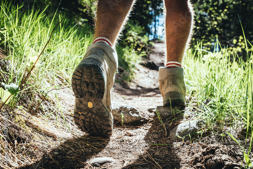 Hiking man in the forest and close up hiking boots