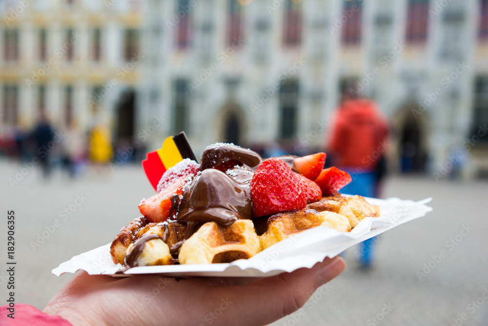 Fototapeta premium Traditional Belgian dessert - waffle with strawberry and cream. Brugge, Belgium
