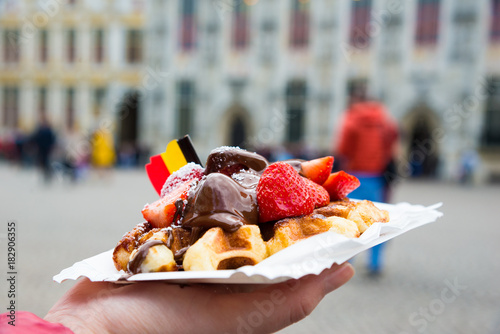 Traditional Belgian dessert - waffle with strawberry and cream. Brugge, Belgium