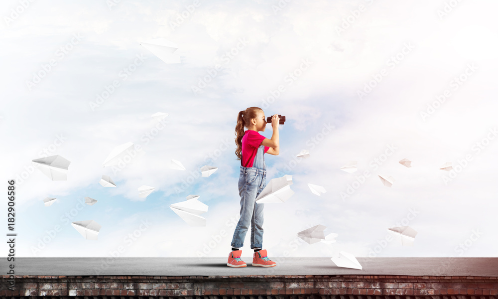 Concept of careless happy childhood with girl of school age looking in future Concept of careless happy childhood with girl of school age looking in future