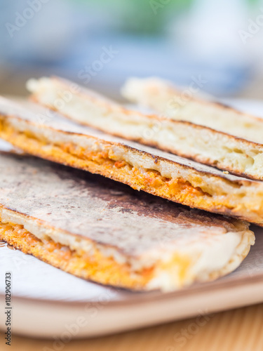 Bolo levedo, typical bread from Azores, grilled with cheese and choriso photo