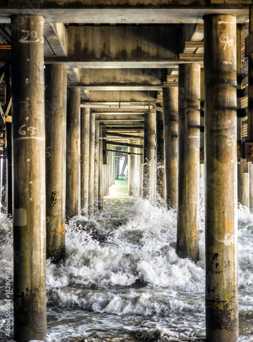 Waves crashing the pillars under the Santa Monica Pier - Santa Monica, Los Angeles, LA, California, CA, USA photo