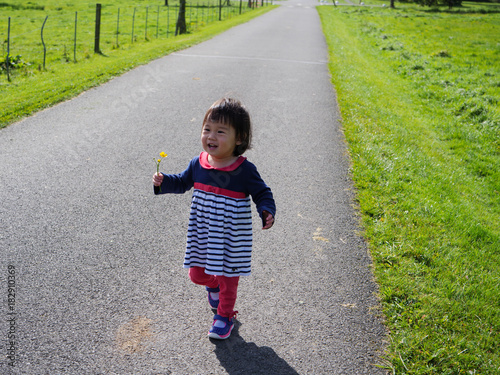 Baby girl playing at Autumn outdoor park photo