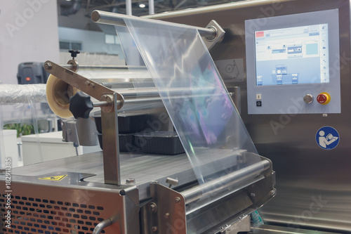 Photos Machine for packing food products close-up. Industry