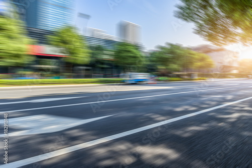 Empty urban road and modern buildings under blue sky