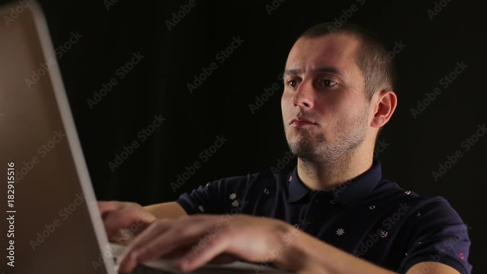 male using laptop notebook isolated black background male using laptop notebook isolated black background