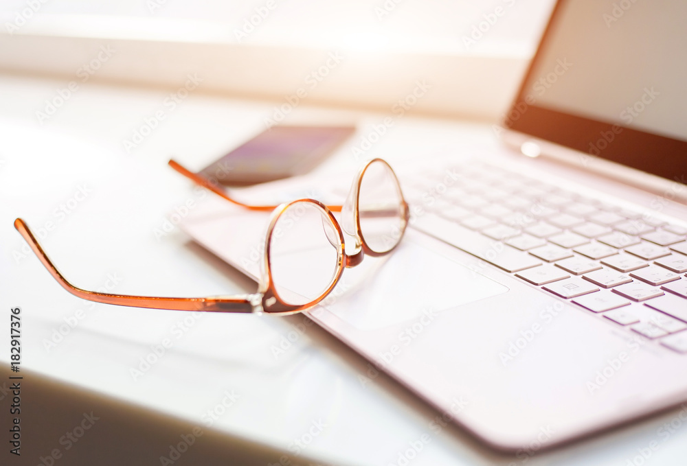 Desk with laptop, eye glasses, and a cup of coffee. Concept of business Desk with laptop, eye glasses, and a cup of coffee. Concept of business