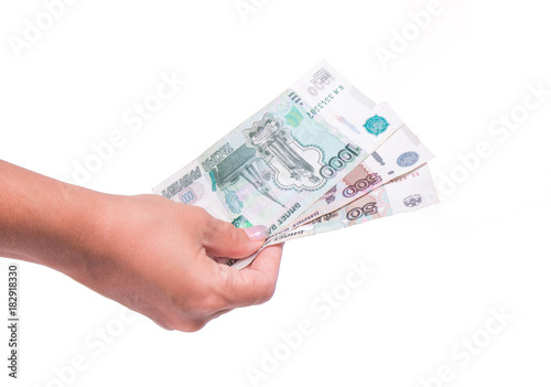 Human hand holding money, sharing ruble banknotes. Isolated on white background. Hand giving ruble banknotes in financial, money exchange and donation concepts.