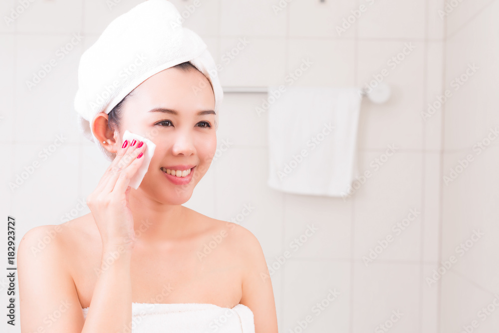 Beautiful woman applying cosmetic cream in bathroom. Beautiful woman applying cosmetic cream in bathroom.