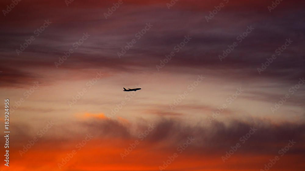airplane landing in sunset