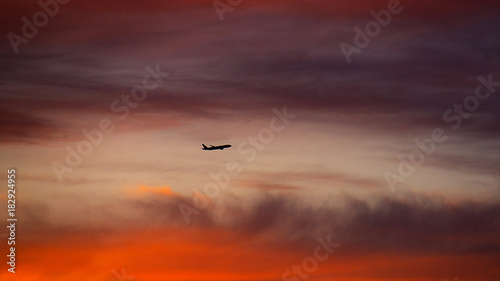 airplane landing in sunset