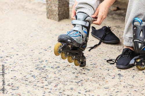 Woman putting on roller skates outdoor.